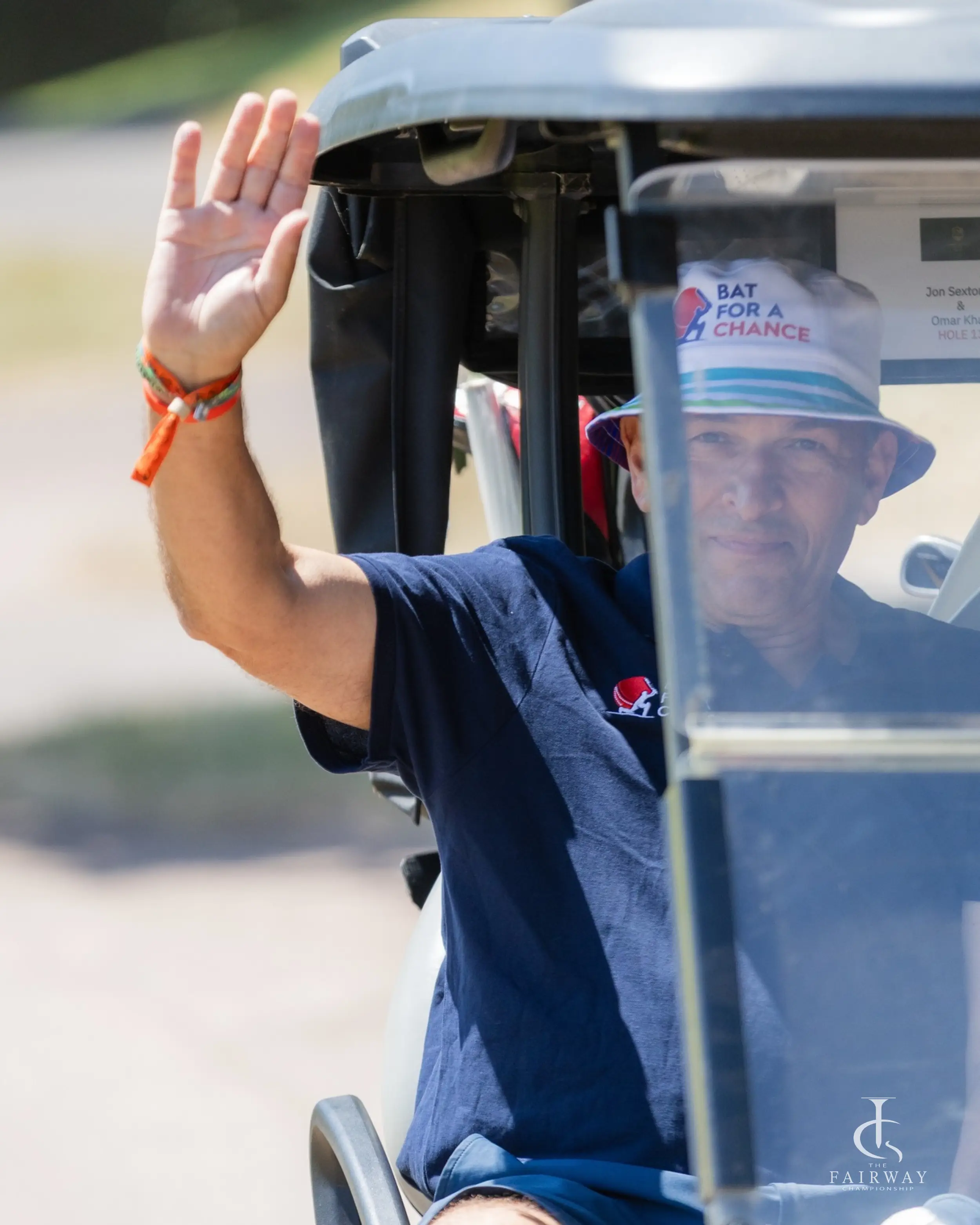 Golfer waving from a golf cart at Fairway Championship 2026