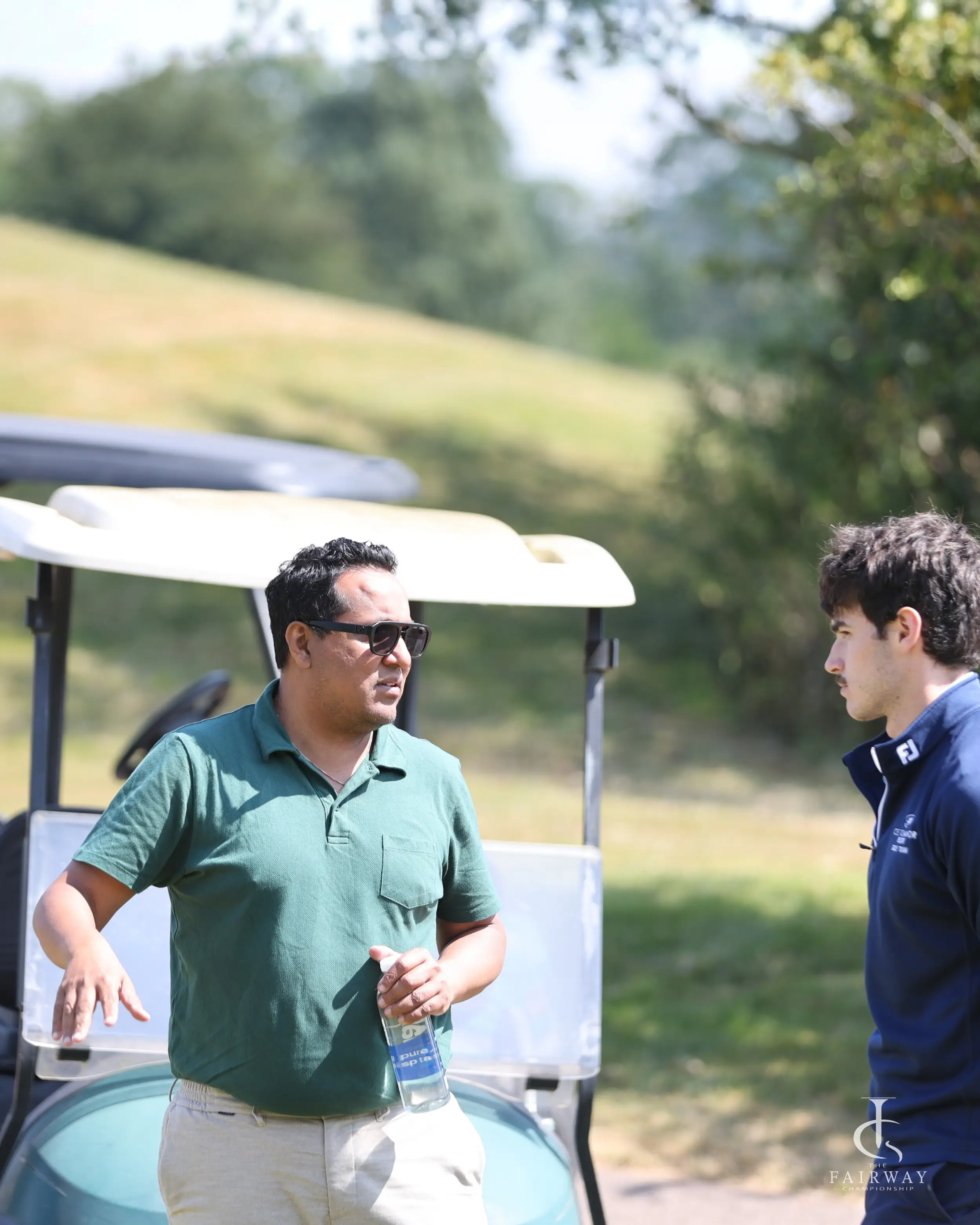 Players talking by a golf cart at Fairway Championship 2026