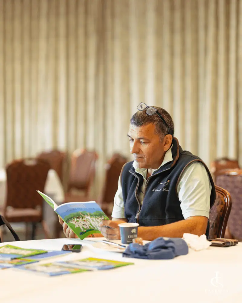 Guest reading the tournament programme at Fairway Championship 2026 registration