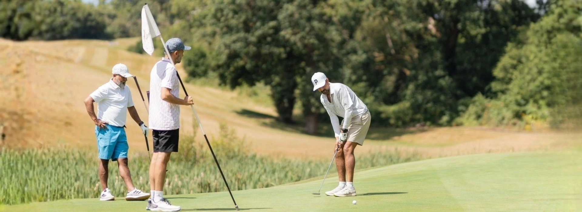 Golfers putting on the green during the Fairway Championship Invitational